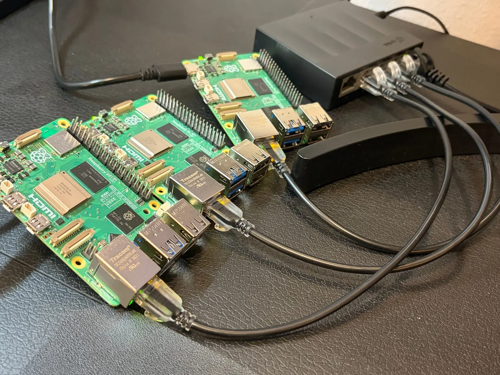 The three Pis each connected by an Ethernet cable to a small gigabit switch
